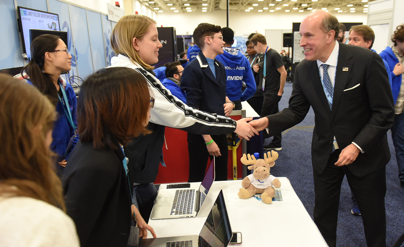 U.S. Department of Energy Under Secretary for Science Paul M. Dabbar greets students on the exhibition floor of SC18.