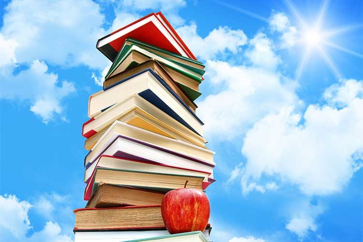 stack of books against cloud background
