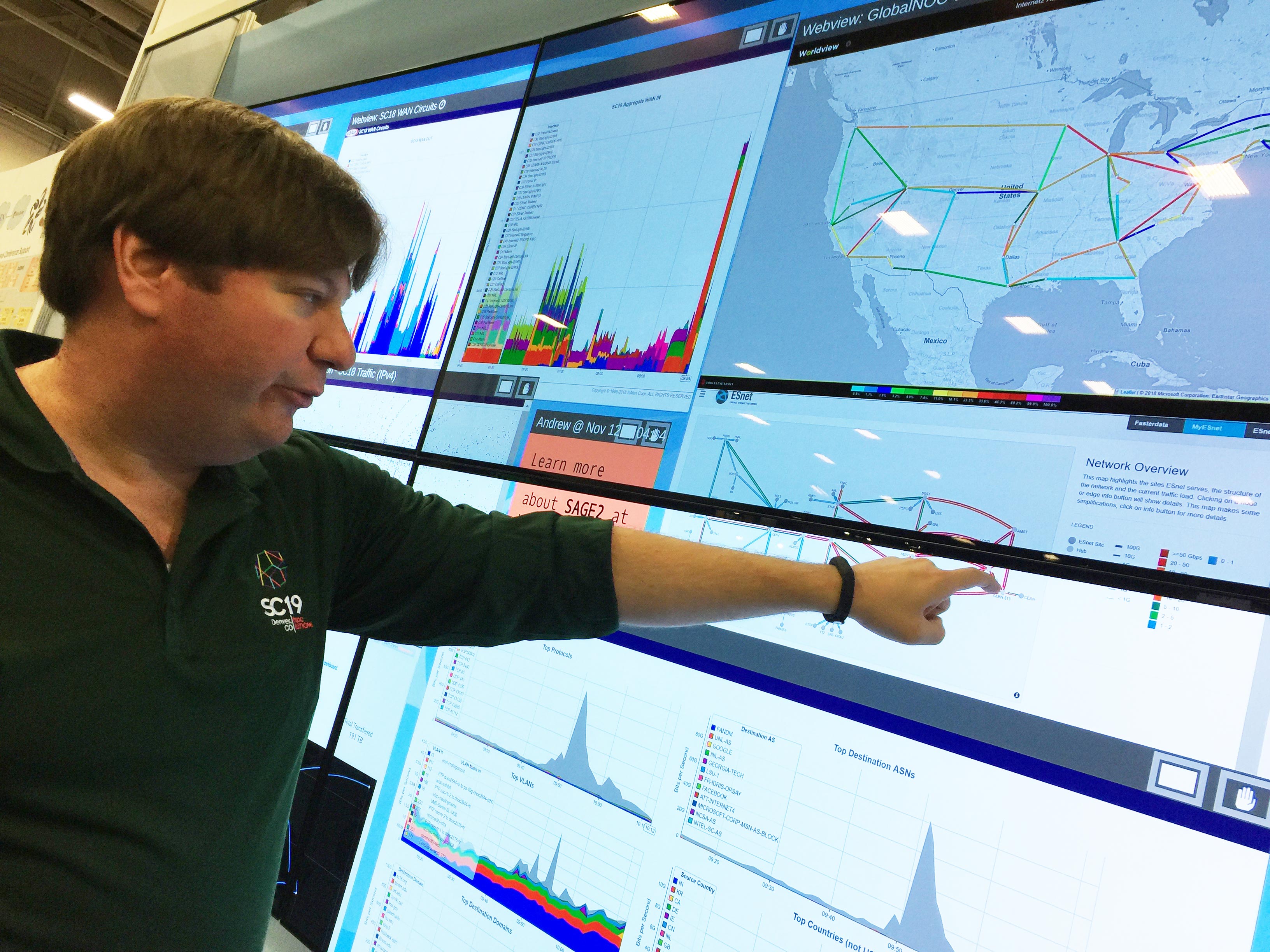 SCinet Chair Jason Zurawski shows latest trends on a giant data visualization monitor for the world's fastest temporary network.