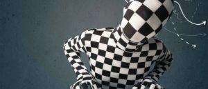 human in checkerboard body suit at keyboard