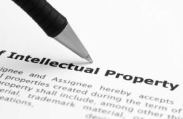 Managing Intellectual Property in a Music Fruition Environment article, close up of pen on paper with intellectual property definition